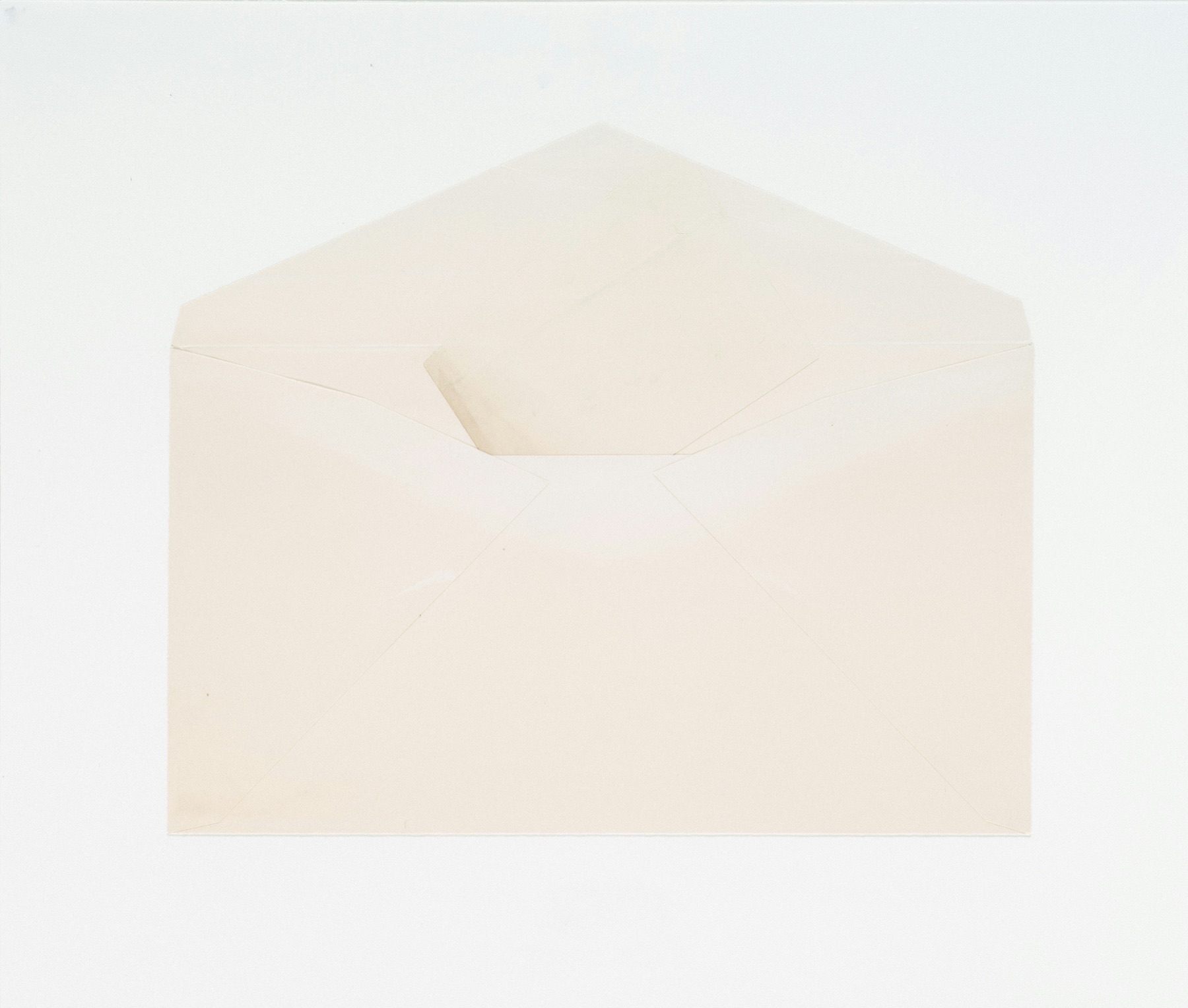 Open cream envelope on warm paper